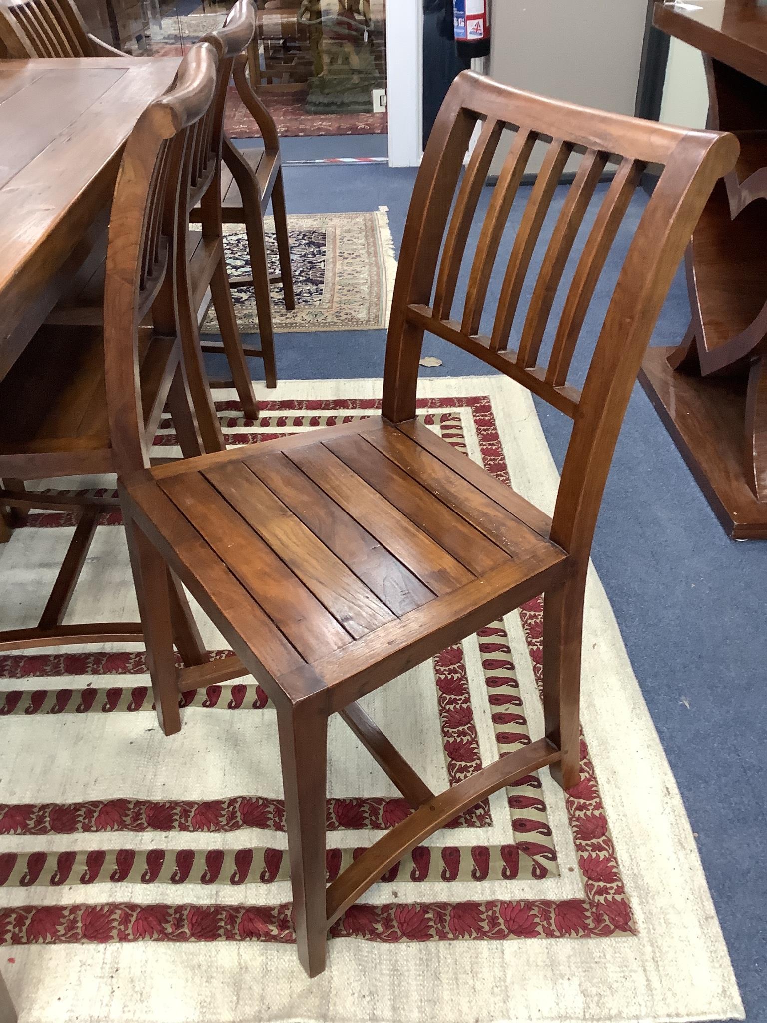 An 18th century style teak rectangular topped dining table and eight chairs